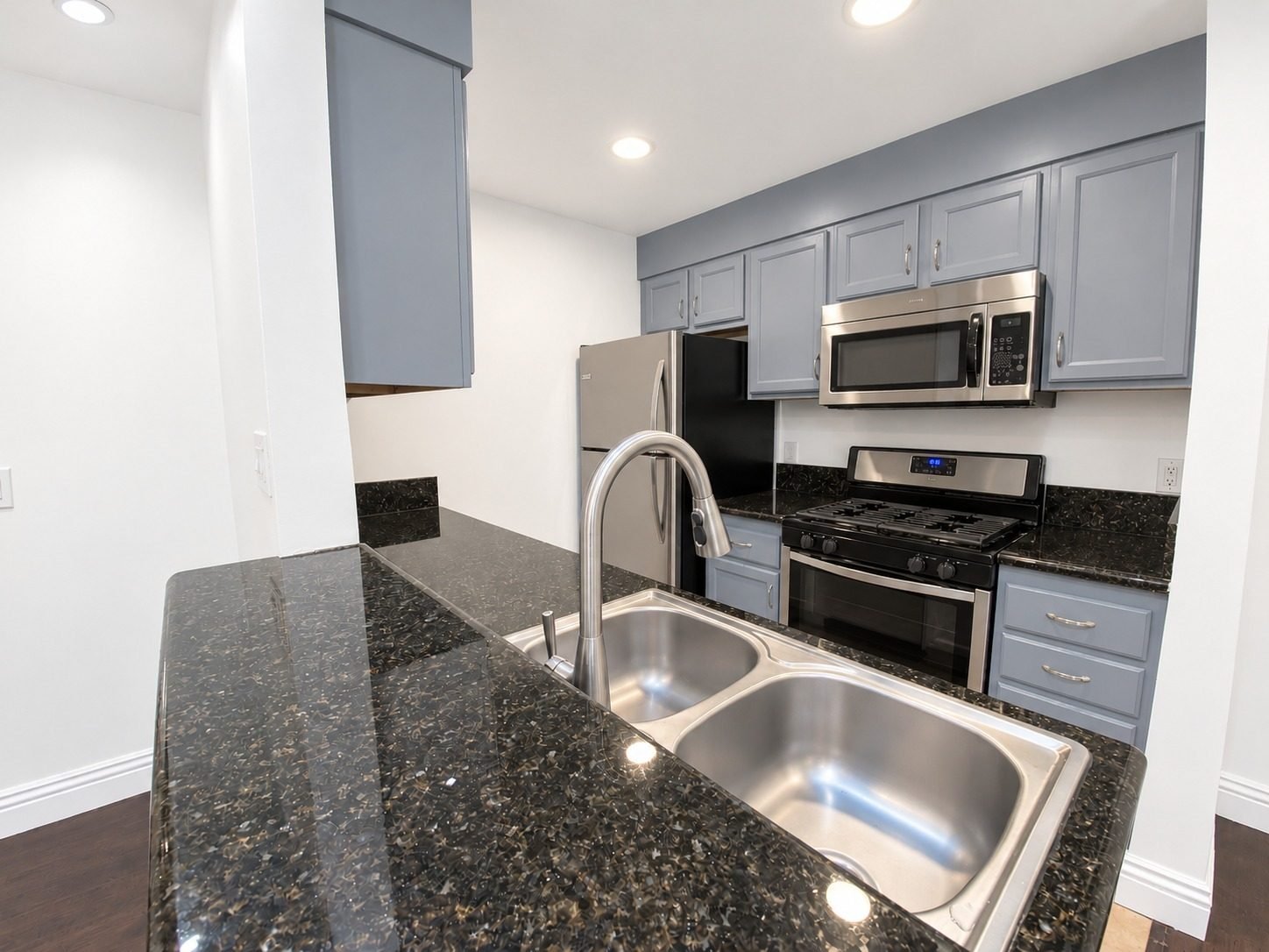 Residence 8 kitchen with granite counters, stainless appliances and gas range