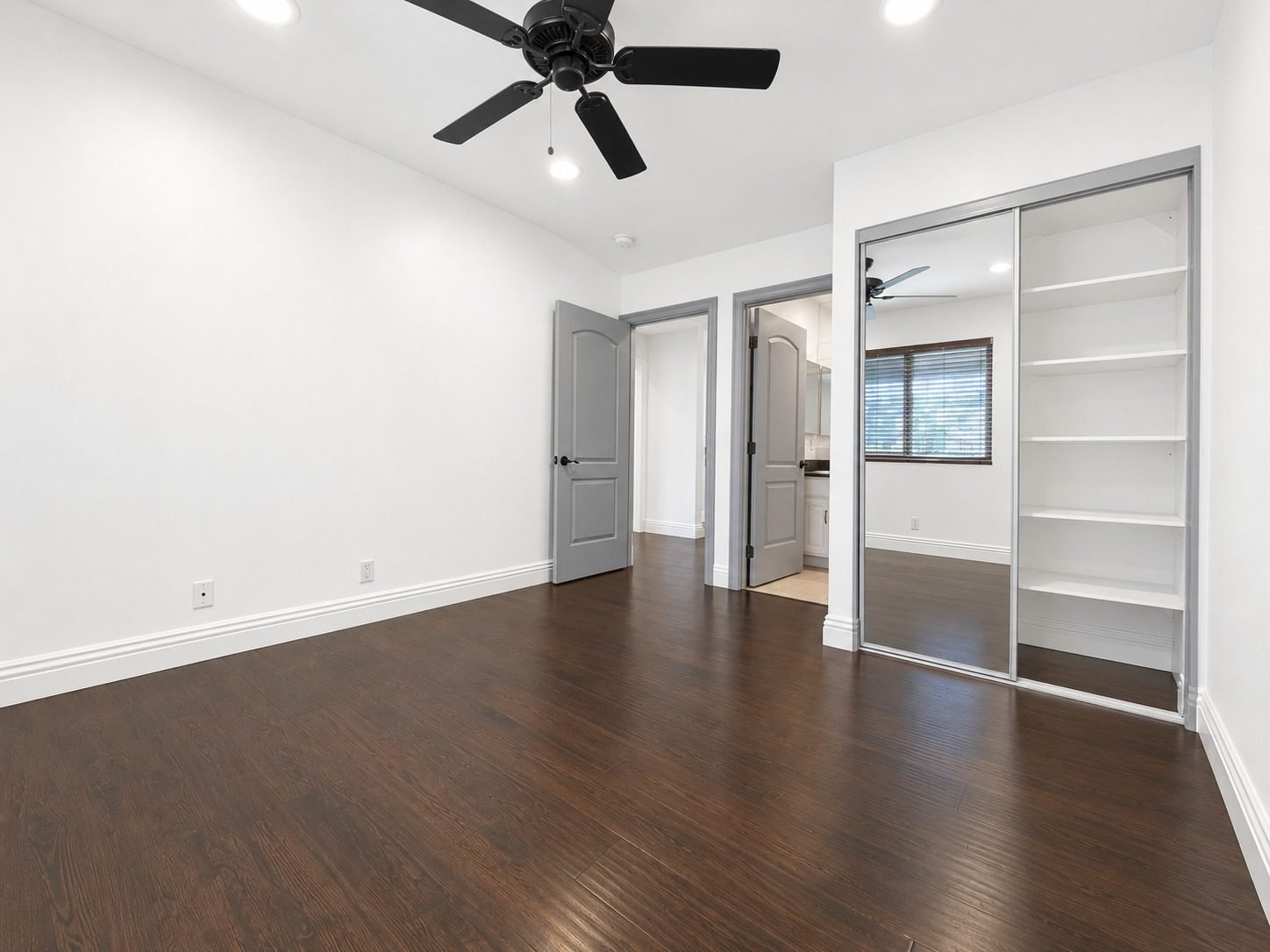Residence 8 bedroom with mirrored closet and shelving