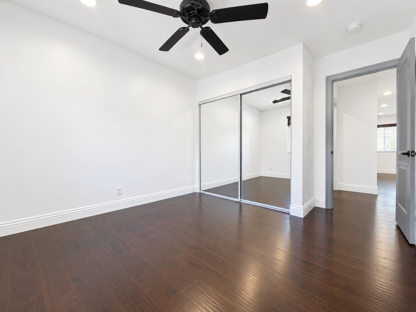 Residence 8 bedroom with mirrored closet and ceiling fan
